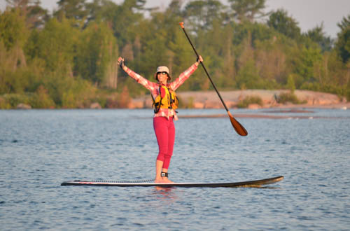 Student excited to be on a SUP board at White Squall Paddling Centre
