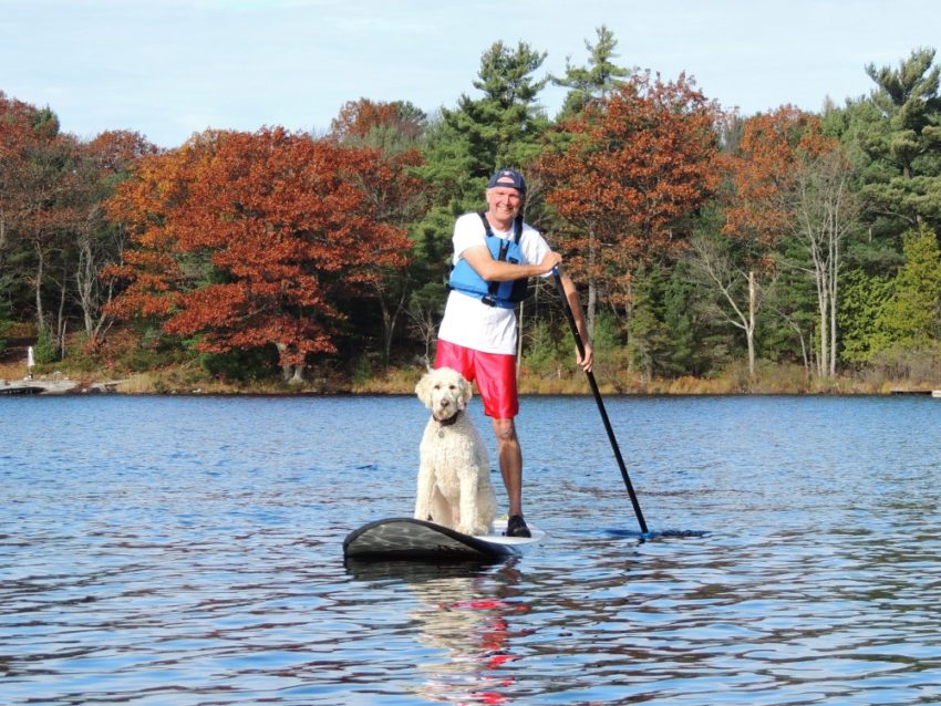 Tim Dyer and dog on a SUP board at White Squall Paddling Centre
