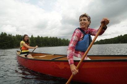 Two staff in canoes at White Squall Paddling Centre