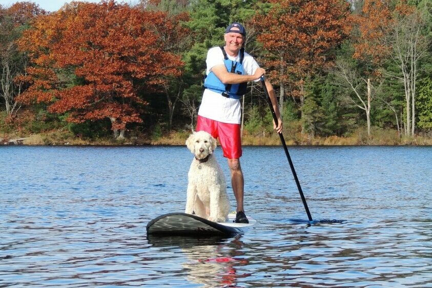 Tim Dyer and dog on a SUP board at White Squall Paddling Centre